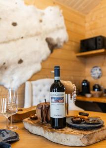 a bottle of wine sitting on a wooden table at Tupa Lodge by The Guide Father in Rovaniemi +25 photos