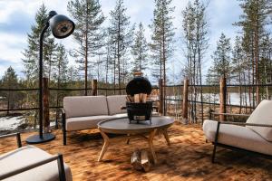 a living room with a couch and a table at Tupa Lodge by The Guide Father in Rovaniemi