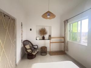 a living room with a chair and a window at Casa Tota in Assomada