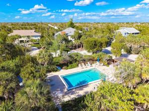 an overhead view of a swimming pool in a yard with trees at Bentley Beach House in Sanibel