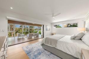a white bedroom with a large bed and windows at Bentley Beach House in Sanibel +97 photos