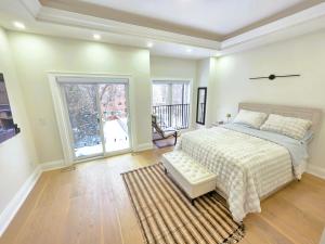a large bedroom with a bed and a large window at Luxury House with Open Living Space in Toronto