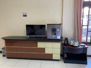 a desk with a television on top of it at Dya Hotel Boyolali in Boyolali +39 photos