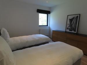 a bedroom with two beds and a window at Appartement 2 chambres Rochefort in Rochefort +2 photos