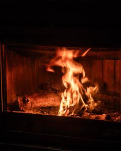 a fire in a fireplace with flames at Casa Tomás in Calaceite
