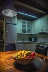 a bowl of fruit on a table in a kitchen at Casa Tomás in Calaceite +2 photos