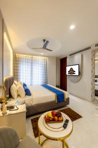 a bedroom with a bed and a table with a plate of food at Hotel Anu Plaza - Newly Built Hotel With Parking Just 6 Mins from Connaught Place ,New Delhi Railway Station & Metro Station in New Delhi