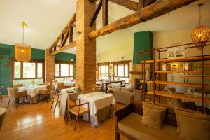 a restaurant with tables and chairs in a room at Hospedium Hotel Rural Ruta Imperial H-CC-00660 in Jarandilla de la Vera