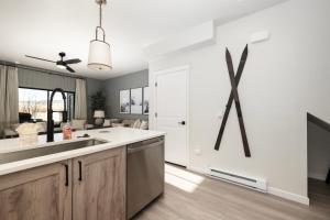 a kitchen with a sink and a refrigerator at 103 Granby Meadow Dr in Granby +12 photos