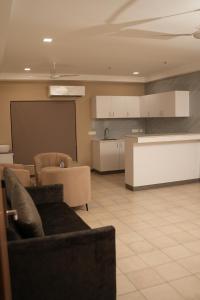 a room with couches and a classroom with a chalkboard at Hotel Bariz Perinthalmanna in Perintalmanna