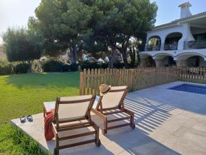 two chairs sitting on a patio in front of a house at Chichen Itza in Moraira