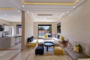 a living room with a couch and a table at Dar El Gharrabia villa entièrement privatisée in Amezrou