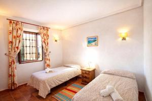 a bedroom with two beds and a window at La Casona del Olivo - Pool, Patio, BBQ & Pet-Friendly in Torre-Pacheco