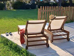 two rocking chairs and a hat sitting on a patio at Chichen Itza in Moraira