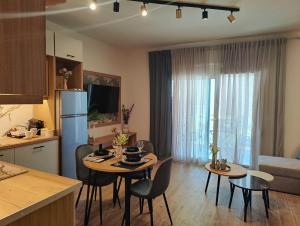a kitchen and living room with a table and chairs at Sandy'sLuxuryApartment in Alexandroupoli +25 photos
