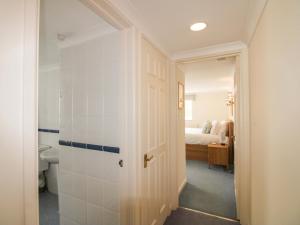 a bathroom with a toilet and a white door at Orchard Barn in Salcombe +40 photos