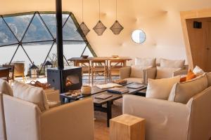 a living room with chairs and a fireplace at Moreno Camp - Glamping with a view in El Calafate