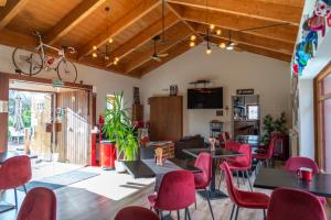 a room with tables and chairs and a bike on the ceiling at CicloLodge in Lozoya