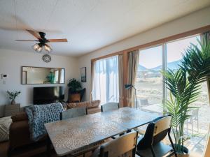 a living room with a table and a couch at Aso Grand View in Aso