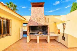 a brick fireplace on a patio of a house at La Casona del Olivo - Pool, Patio, BBQ & Pet-Friendly in Torre-Pacheco