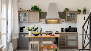 a kitchen with a wooden table in a kitchen at VILLA PERELLE 8, Emma Villas in Rio nellʼElba