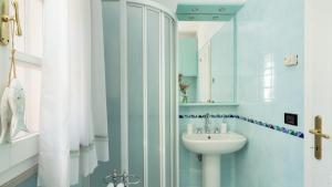 a bathroom with a sink and a mirror at VILLA PERELLE 8, Emma Villas in Rio nellʼElba +31 photos