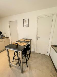 a kitchen with a table and chairs in a room at Maisonnette des vignes in Albertville +21 photos