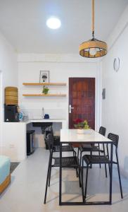 a dining room with a table and chairs at Happy Island Inn in Virac