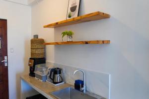 a kitchen with a sink and a counter top at Happy Island Inn in Virac