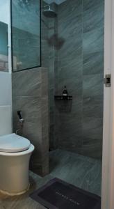 a bathroom with a toilet and a glass shower at Happy Island Inn in Virac +74 photos