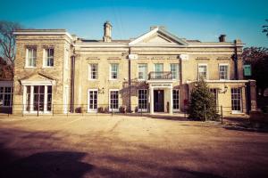 a large brick building with a lot of windows at Banyers House in Royston