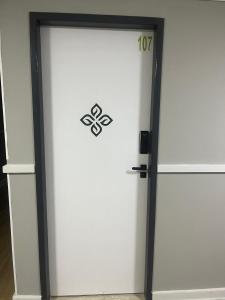 a white garage door with a sign on it at Zuppolini Garden apart-hotel in Bananeiras