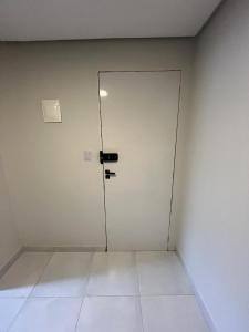 a door in a room with a white wall at Zuppolini Garden apart-hotel in Bananeiras