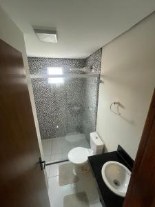 a bathroom with a shower and a toilet and a sink at Zuppolini Garden apart-hotel in Bananeiras