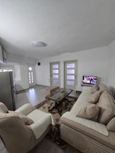 a living room with two couches and a tv at Rina House in Žabljak