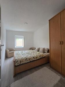a bedroom with a bed and a dresser in it at Rina House in Žabljak