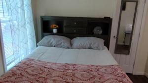 a bedroom with a bed with a headboard and a window at McAfee Private Room Shared Bathroom 1 in Decatur