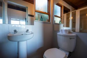 a bathroom with a white toilet and a sink at A Stone's Throw in Grahamstown