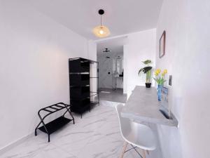 a white room with a table and chairs in it at Downtown Suites - Hotel Boutique by Maraf in Cancún