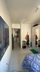 a white room with a bed and a hallway at Quarto Astral in Recife