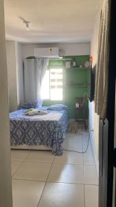 a small bedroom with a bed and a window at Quarto Astral in Recife