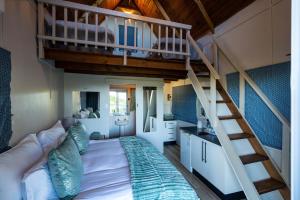 a bedroom with a bunk bed and a staircase at A Stone's Throw in Grahamstown