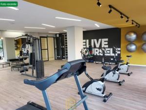 a gym with three exercise bikes in a room at Apartamento Studio in Arujá
