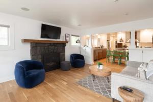 a living room with a couch and a fireplace at The Modern Cottage in Bend