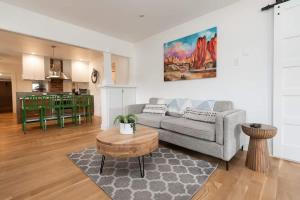 a living room with a couch and a table at The Modern Cottage in Bend