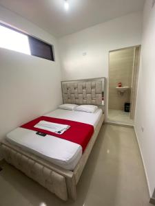 a bedroom with a large bed with a red blanket at Apartamento Tercer Cielo 203 in Cúcuta