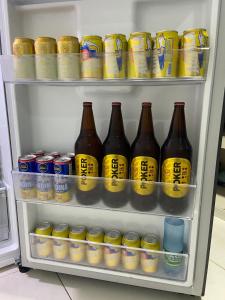 a refrigerator filled with lots of drinks and soda cans at Apartamento Tercer Cielo 203 in Cúcuta