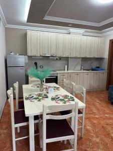 a kitchen with a white table with a plant on it at apartament gezuar in Golem