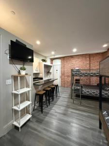 an open kitchen and living room with a brick wall at 31 Street Broadway Hotel in New York