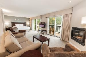 a large living room with a bed and a fireplace at Rosario Resort in Eastsound